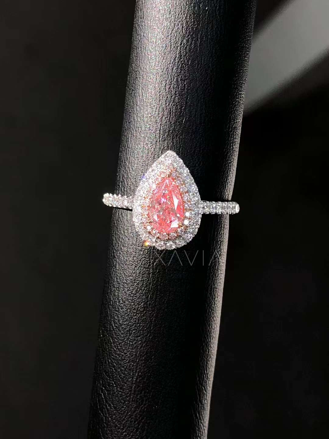 close-up view of pink pear lab diamond ring with double halo on display